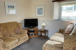 Swift Cottage -  seating area and TV in open plan lounge