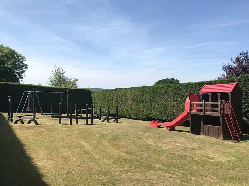 Play area with slide and swings